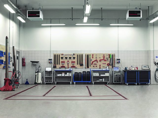 Auto Repair Shop Interior with Mechanic in Background reznor